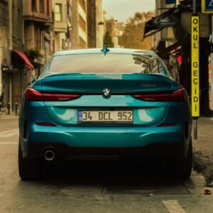 Rear view of a blue BMW 330d parked on a street in İstanbul with urban surroundings.